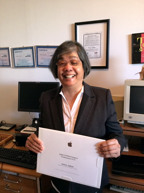 A smiling Donna Jodhan holds her ACSP Certificate.
