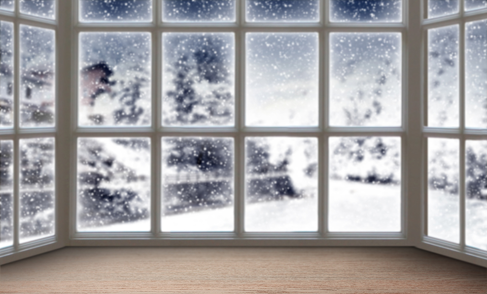 Blurred background of a large picture window with a beautiful winter landscape in the background.