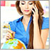 Photo of a woman at a travel agency on the phone with a pencil in her other hand pointing at a globe.