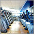 Photo of a beautiful gym with rows and rows of different machines.