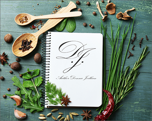 Author Donna Jodhan Recipe Library Subscription Logo: On top of an aged wooden table sits a color collection of many different dried spices all decoratively surrounding a single spiral notebook in the center of the photo. This notebook is open to a blank page, upon which sits the Author Donna Jodhan logo, directly in the center. Welcome to the Author Donna Jodhan Recipe Library Subscription.