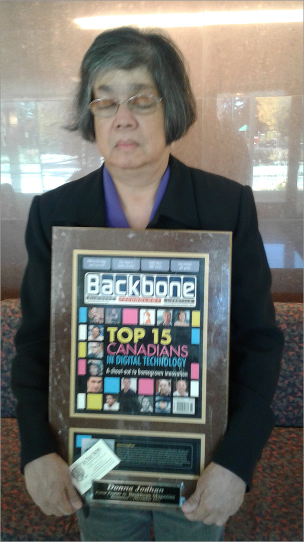 A photo of Donna Jodhan holding the Award presented by Backbone Magazine for being named one of the Top 15 Canadians in Digital Technology.
