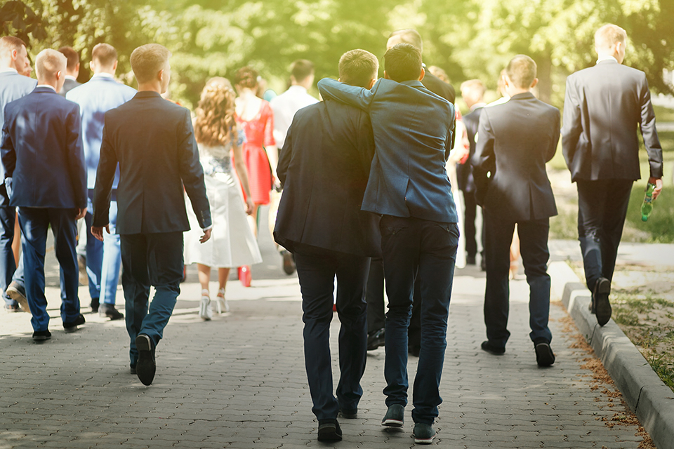 Group of well dressed friends walking together at a reception on a sunny day. Graduation. Prom.
