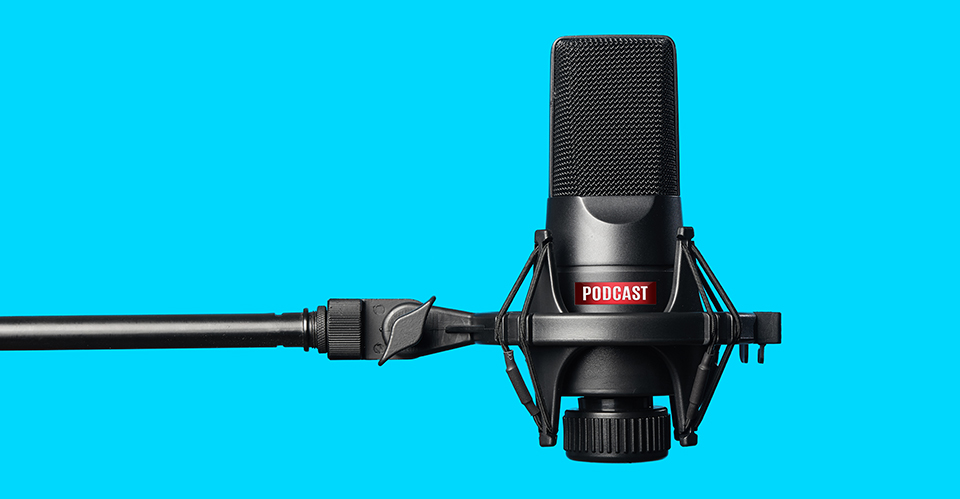 A studio microphone for recording podcasts over a blue background.