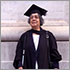 Donna Jodhan stands smiling in her cap and gown in front of the University of London England on July 14th 2022 where she was awarded her Law Degree.