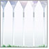 Photo of a beautiful white picket fence on bright green grass against a beautiful blue sky covered in clouds.