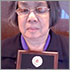 Photo of Donna Jodhan holding the 2010 National Award  presented by The Council of Canadians with Disabilities for Recognition of Valued Contribution to the Disability Rights Movement in Canada.